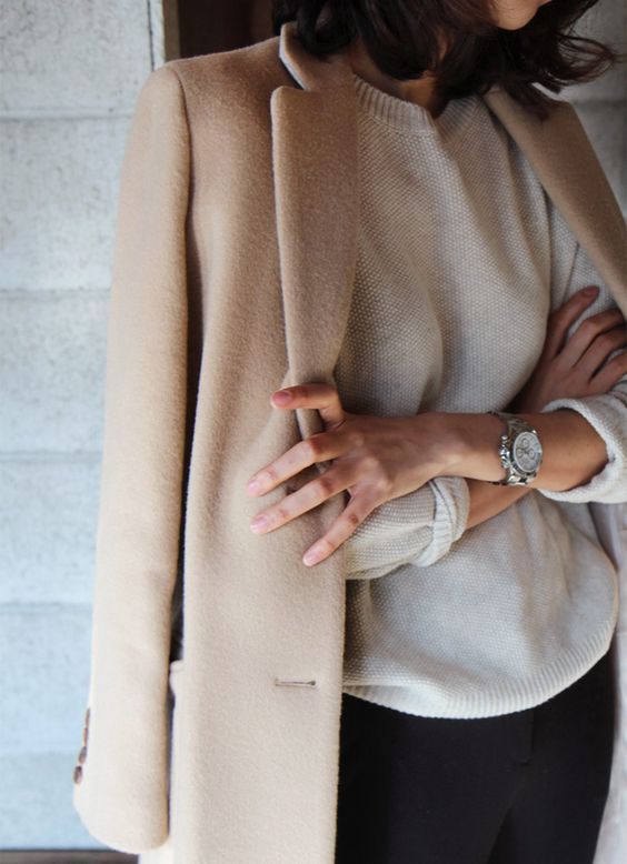 black pants, a white cashmere sweater and a camel coat can be worn to work