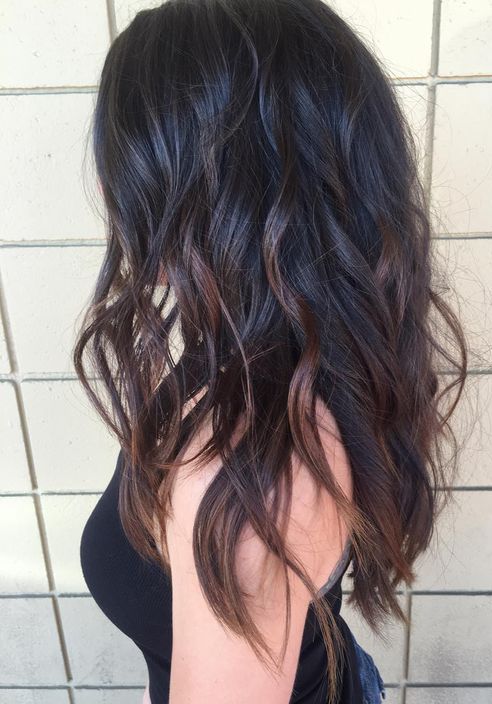 black wavy hair with red balayage looks very sexy