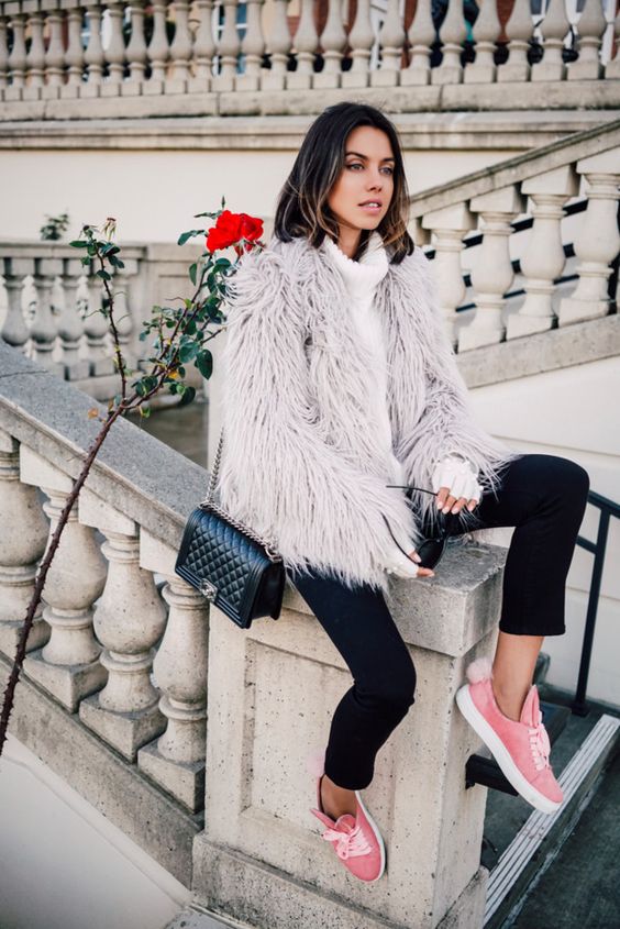 black cropped pants, a white sweater, a fuzzy faux fur coat and pink sneakers