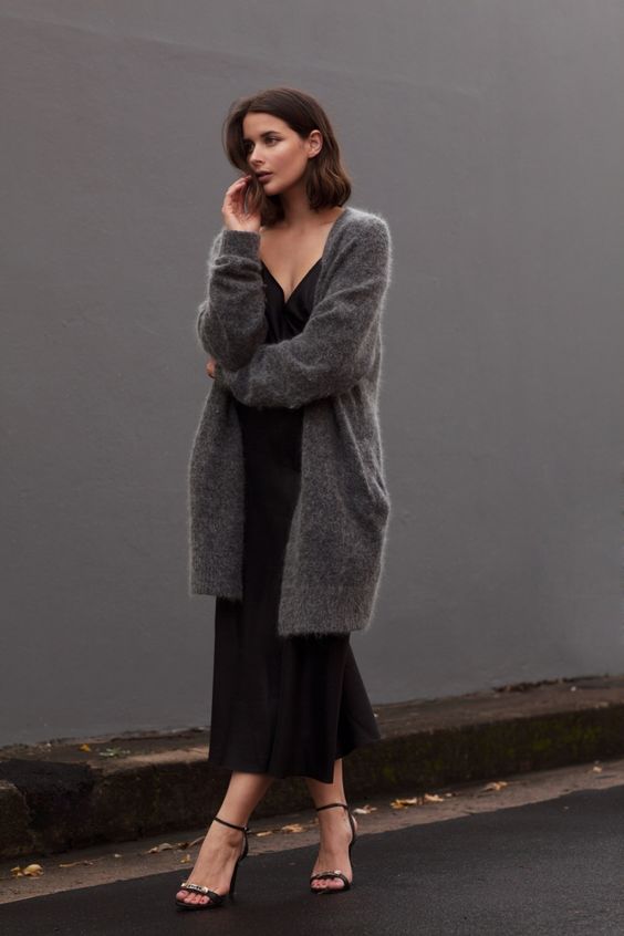 a black slip midi dress, strappy heels and a dark grey cashmere cardigan for a sexy yet comfy look