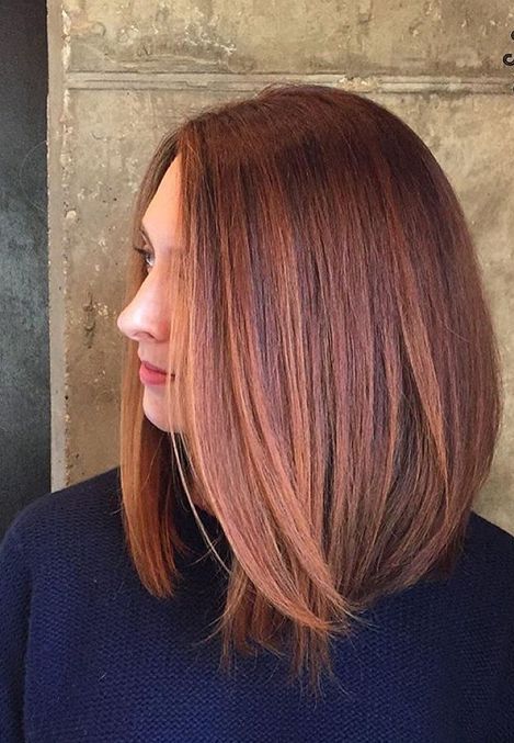 bold red hair with rose gold highlights on medium length hair
