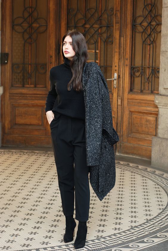 black cropped pants, a black turtleneck, black suede booties and a coat
