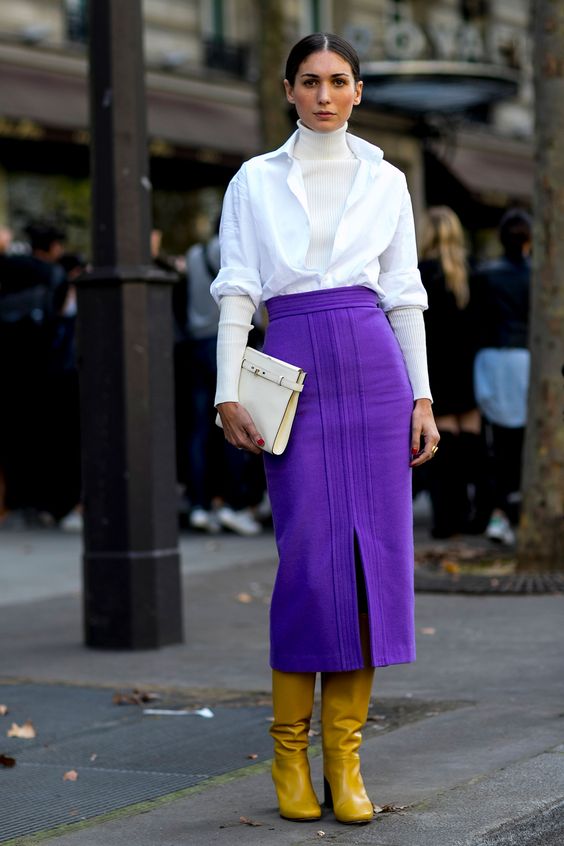 yellow boots, an ultraviolet midi skirt with a slit, a white shirt and a sweater
