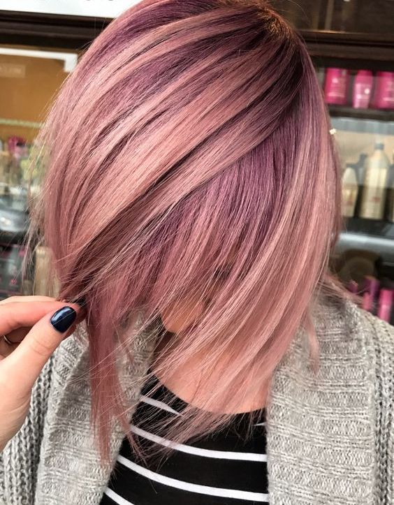 fair hair and rose gold highlights with an angled cut for a bold look