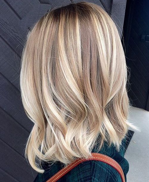 wavy bronde hair with lots of blonde balayage to look bold and cool