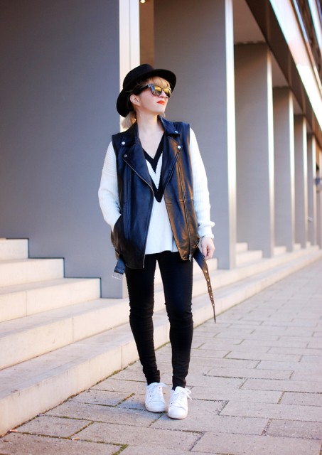 With black and white sweatshirt, skinny pants, wide brim hat and white sneakers