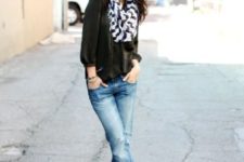 With black blouse, cuffed jeans and platform shoes