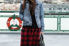 With black shirt, denim jacket, black beanie, black tights, red boots and black bag