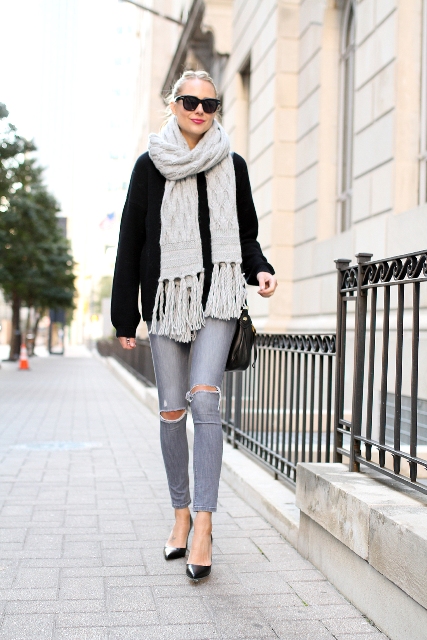 With black sweater, gray distressed jeans, black pumps and black bag