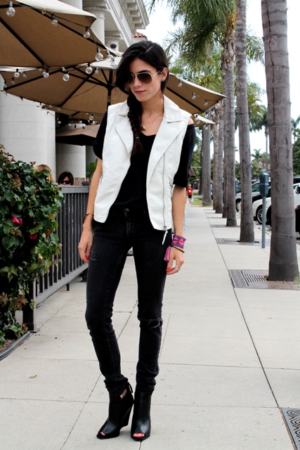 With black t-shirt, black pants, cutout boots and sunglasses
