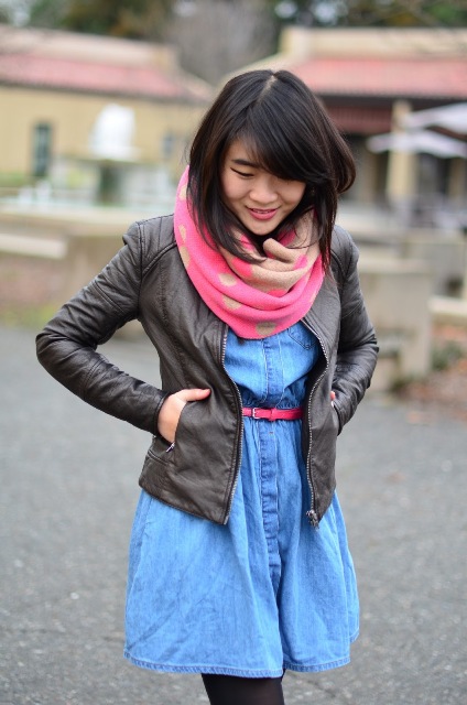 With denim dress, leather jacket and pink belt