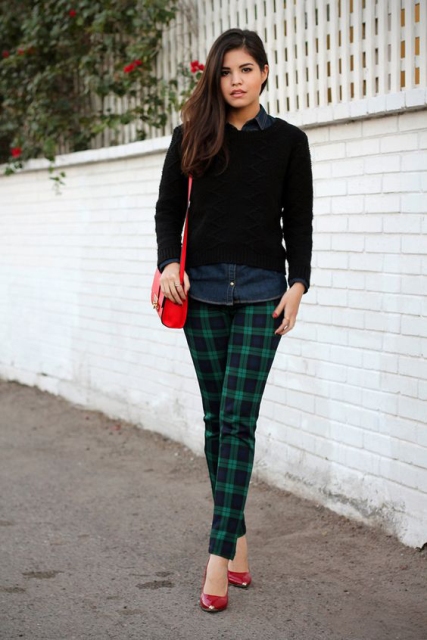 With denim shirt, black sweater, red pumps and red bag