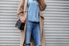 With denim shirt, distressed jeans, black ankle boots and mini bag