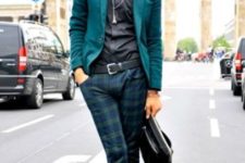 With emerald blazer, black shirt, gray boots and leather bag