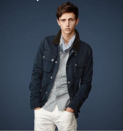 With gray button down shirt, navy blue jacket and white pants