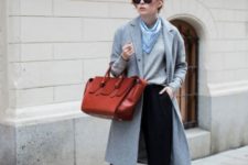 With gray shirt, gray knee-length coat, wide-leg pants and red bag