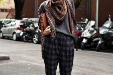 With gray shirt, printed scarf, brown ankle boots and clutch