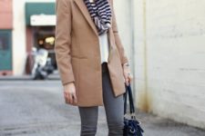 With gray skinny pants, white shoes, white blouse, camel coat and black bag