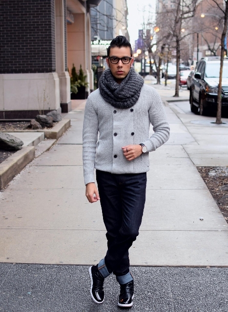 With gray sweater, cuffed jeans and black and white boots