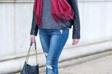 With gray sweater, cuffed jeans, ankle boots, leather jacket and bag