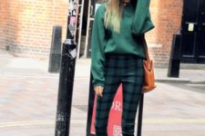 With green loose sweatshirt, brown bag and leather boots