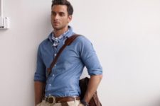 With light blue shirt, beige pants, brown belt and brown bag