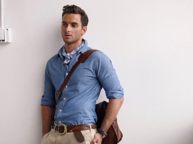 With light blue shirt, beige pants, brown belt and brown bag