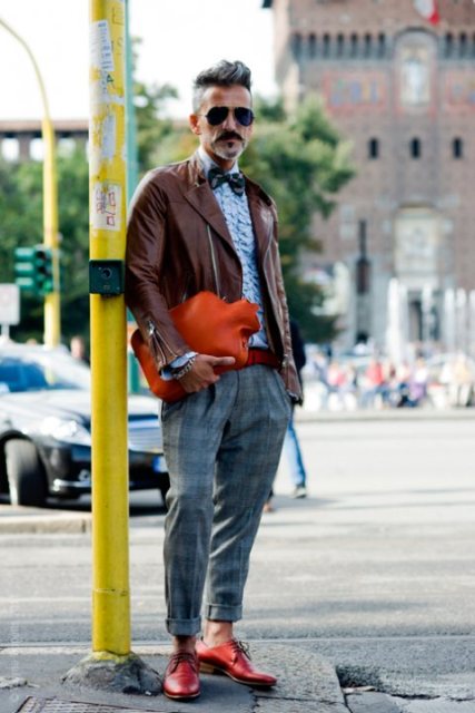 With light blue shirt, bow tie, brown leather jacket and red shoes