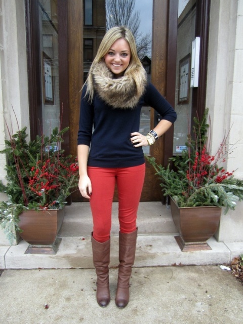 With navy blue shirt, red pants and high boots