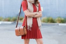With orange dress, brown fringe boots and brown bag