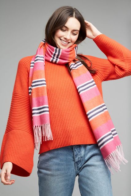 With orange oversized sweater and jeans