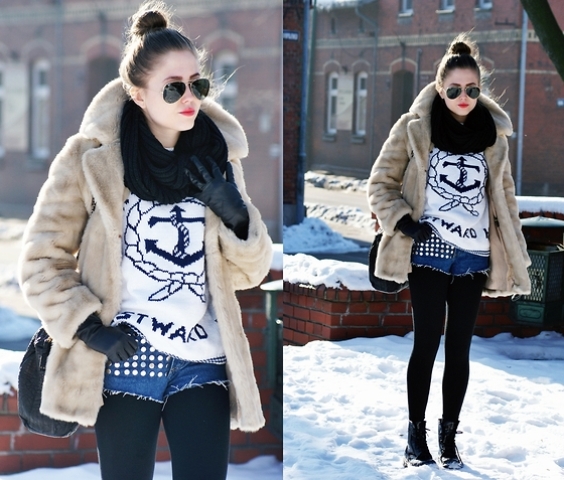 With printed sweatshirt, fur coat, black scarf, lace up boots and black bag