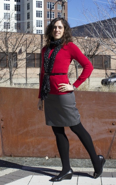 With red shirt, black belt, mini skirt and black shoes