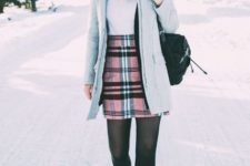 With shirt, lace up boots, light blue coat and red beanie