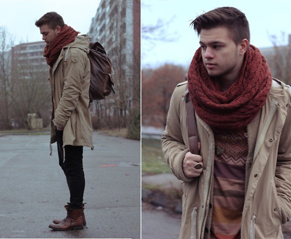 With sweater, pants, brown boots, parka coat and backpack