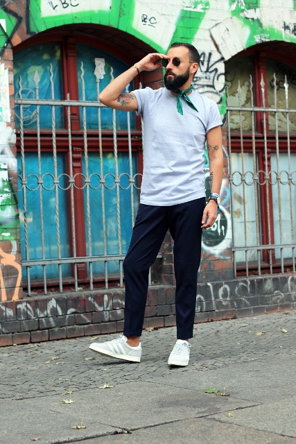 With t-shirt, black pants, white sneakers and sunglasses