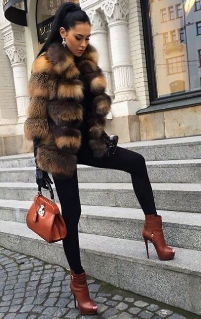 With turtleneck, black leggings, brown ankle boots and brown small bag