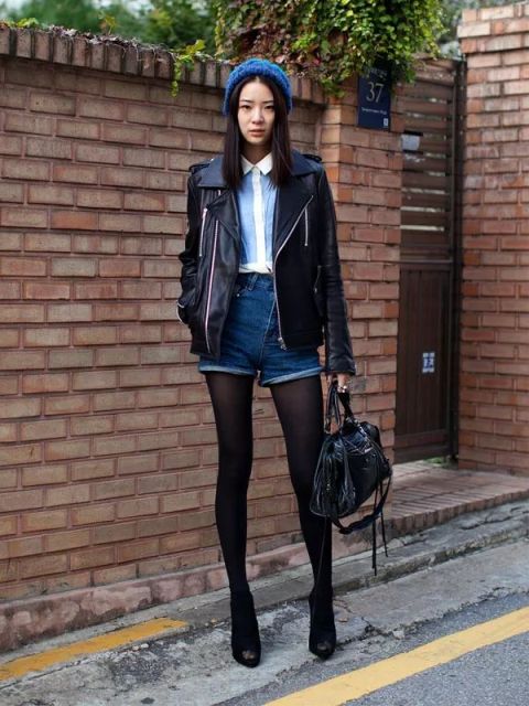 With white and light blue shirt, leather jacket, beanie, black leather bag and ankle boots