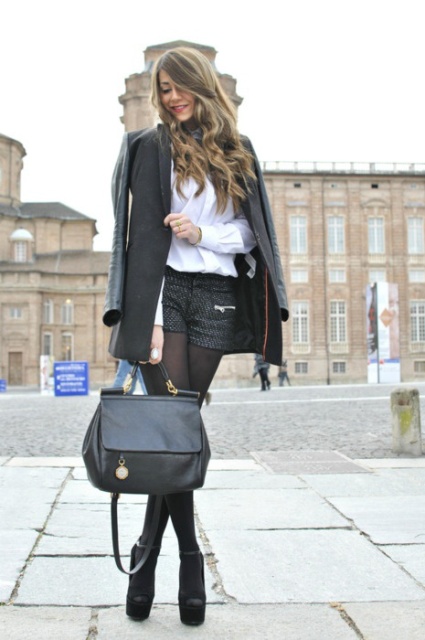 With white blouse, long jacket, black leather bag and platform shoes