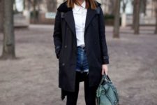 With white button down shirt, black wide brim hat, black tights, ankle boots, black coat and green bag