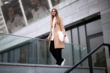 With white button down shirt, camel coat, wide-leg pants and white sneakers