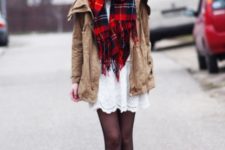 With white dress, brown boots and beige parka coat