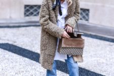With white long shirt, coat, crop jeans, snake print boots and bag