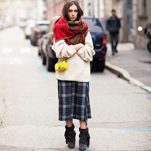 With white oversized sweater, oversized scarf, yellow bag and mid calf boots