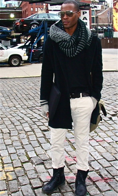 With white pants, mid calf boots, shirt, coat and bag