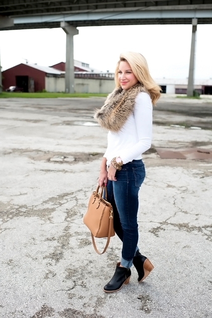 With white shirt, cuffed jeans, ankle boots and camel bag