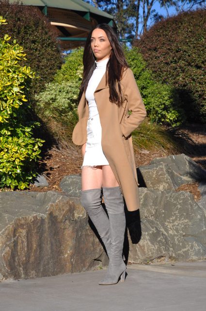 With white shirt, white mini skirt and gray boots