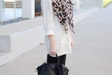 With white sweater dress, black tights, high boots and black small bag