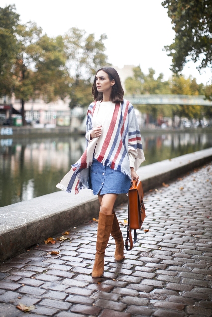 With white t-shirt, denim skirt, high boots and brown leather bag