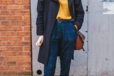 With yellow shirt, funny socks, navy blue coat and bag